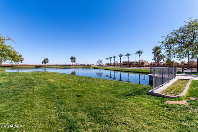 view of yard featuring a water view and fence