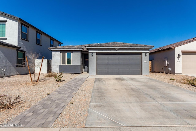 view of front of property featuring a garage, driveway, and stucco siding