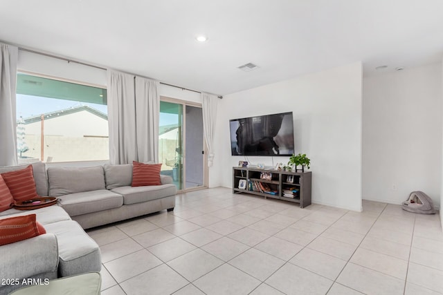 living room with recessed lighting, visible vents, and light tile patterned flooring