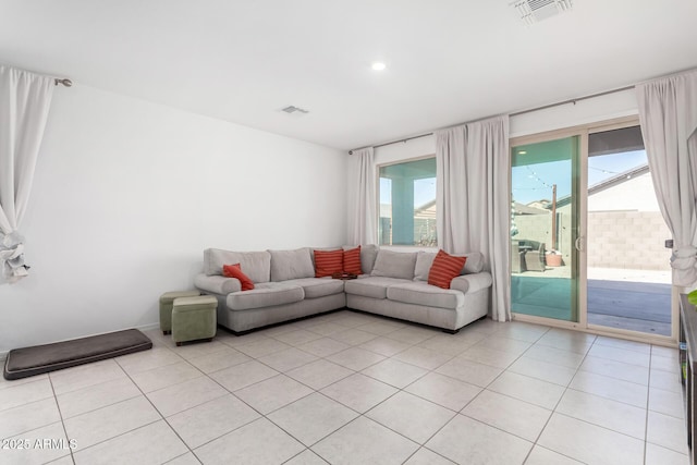 living area featuring light tile patterned flooring, visible vents, and recessed lighting