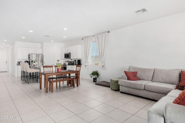 living room featuring recessed lighting, visible vents, and light tile patterned flooring