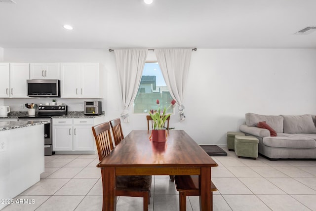 dining space featuring light tile patterned flooring, visible vents, and recessed lighting