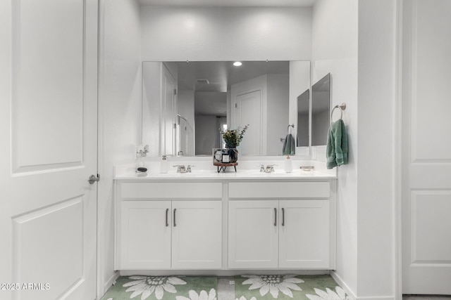 full bathroom with double vanity and a sink