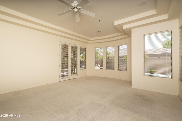 6917 E Night Glow Cir, Scottsdale, AZ 85266 - unfurnished room featuring a raised ceiling, light colored carpet, french doors, and a ceiling fan
