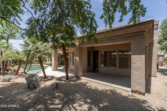 6917 E Night Glow Cir, Scottsdale, AZ 85266 - rear view of property featuring a patio, stucco siding, and an outdoor pool