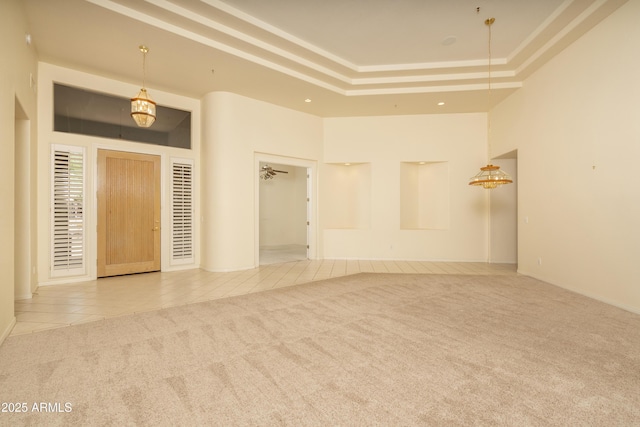 6917 E Night Glow Cir, Scottsdale, AZ 85266 - tiled spare room featuring carpet flooring, a high ceiling, a raised ceiling, and recessed lighting