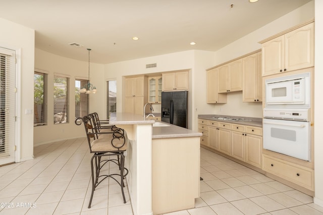 6917 E Night Glow Cir, Scottsdale, AZ 85266 - kitchen with white appliances, a sink, a chandelier, light tile patterned floors, and recessed lighting