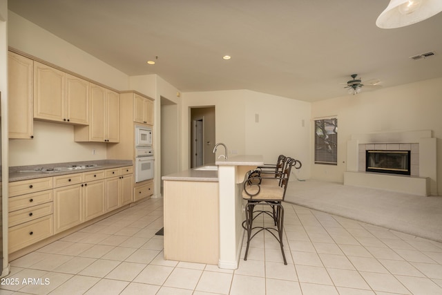 6917 E Night Glow Cir, Scottsdale, AZ 85266 - kitchen featuring white appliances, cream cabinetry, ceiling fan, a sink, and open floor plan