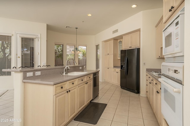 6917 E Night Glow Cir, Scottsdale, AZ 85266 - kitchen with white appliances, a sink, light tile patterned floors, recessed lighting, and cream cabinetry