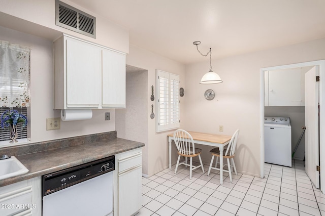 kitchen featuring visible vents, washer / clothes dryer, white dishwasher, white cabinetry, and dark countertops