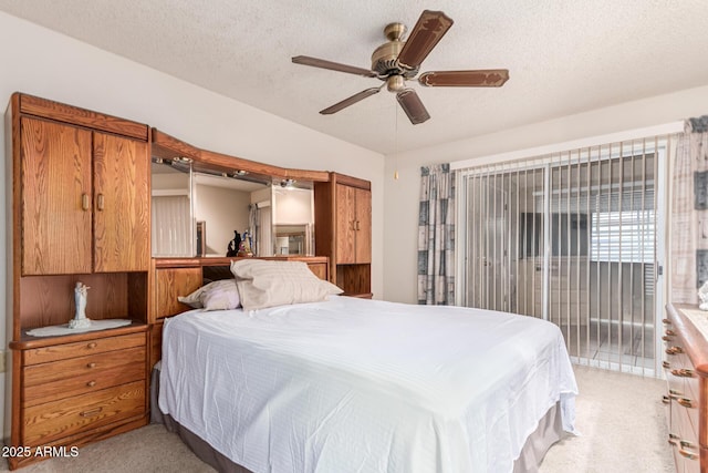 bedroom with light carpet, a textured ceiling, access to exterior, and a ceiling fan