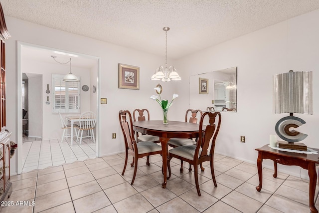 dining area with light tile patterned floors, a textured ceiling, and an inviting chandelier