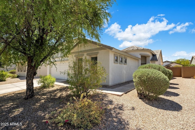2615 W Silver Streak Way, San Tan Valley, AZ 85144 - view of front of house featuring an attached garage, fence, stucco siding, and concrete driveway