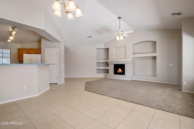 2615 W Silver Streak Way, San Tan Valley, AZ 85144 - unfurnished living room with built in shelves, light tile patterned floors, lofted ceiling, baseboards, and ceiling fan