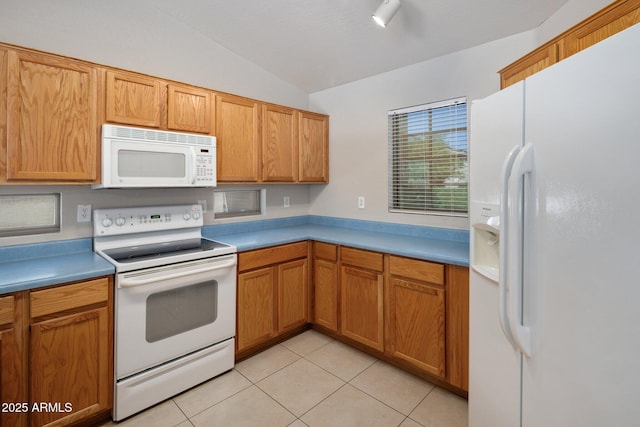 2615 W Silver Streak Way, San Tan Valley, AZ 85144 - kitchen featuring white appliances, lofted ceiling, light tile patterned floors, and light countertops