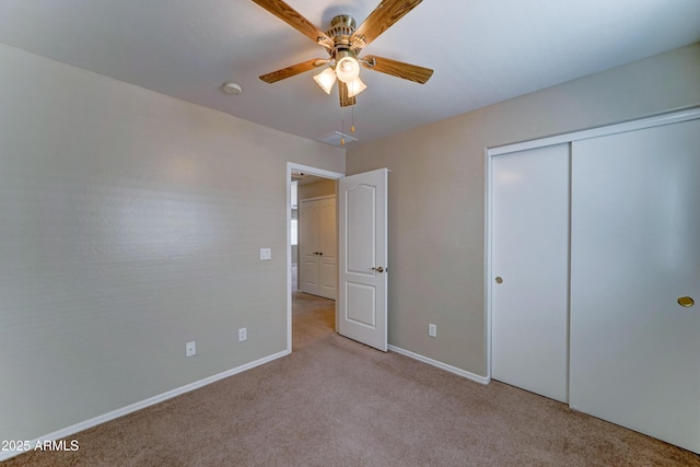 unfurnished bedroom with carpet flooring, baseboards, a closet, and ceiling fan