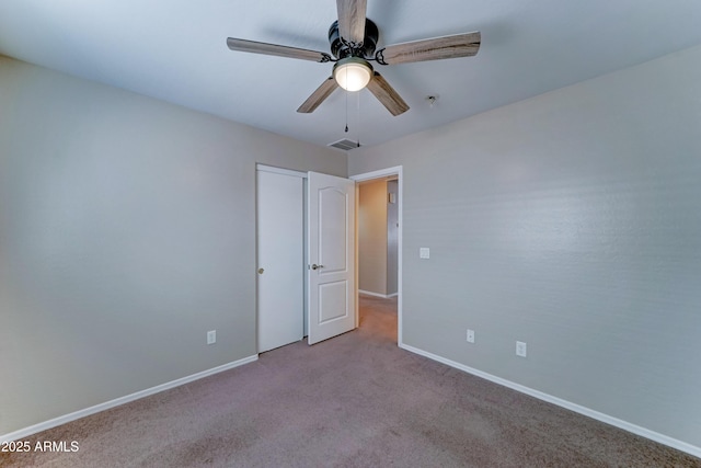 unfurnished bedroom featuring carpet flooring, baseboards, and a ceiling fan