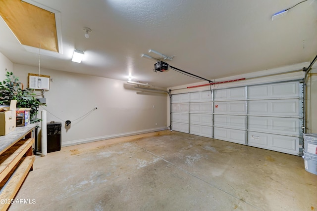 garage with a garage door opener and baseboards