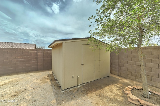 view of shed with a fenced backyard