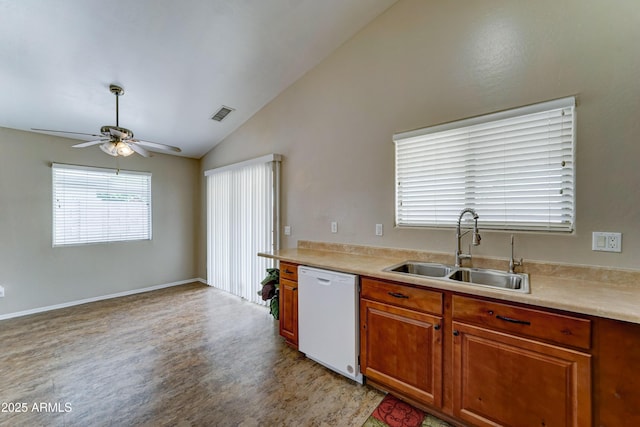 kitchen featuring white dishwasher, a sink, vaulted ceiling, a ceiling fan, and light wood finished floors