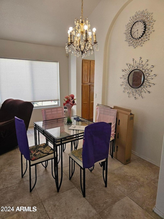 dining room featuring an inviting chandelier and tile patterned floors