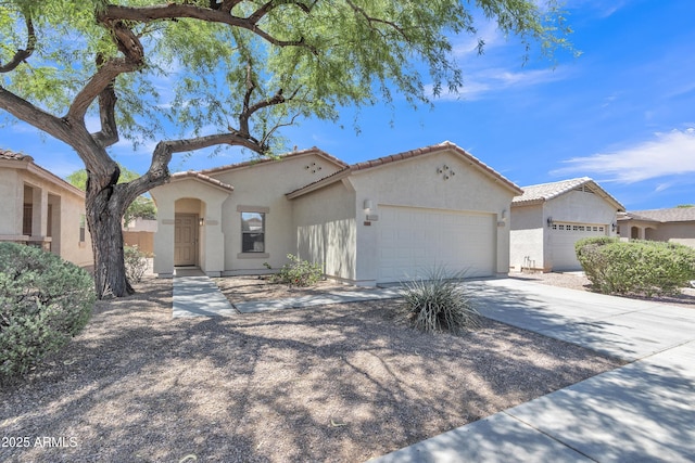 9261 W Sheridan St, Phoenix, AZ 85037 - mediterranean / spanish-style home featuring a garage, stucco siding, a tile roof, and concrete driveway