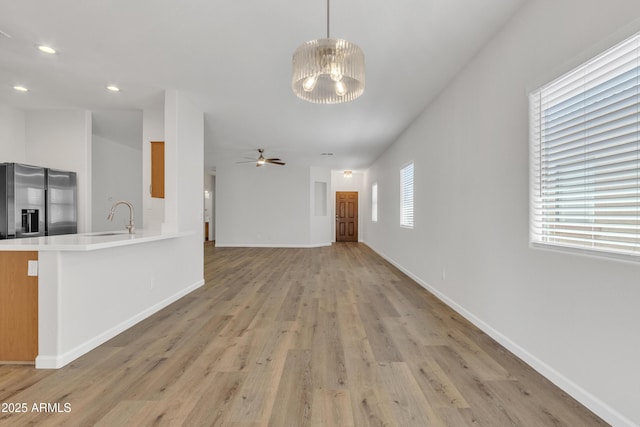 9261 W Sheridan St, Phoenix, AZ 85037 - unfurnished living room with light wood-style flooring, a chandelier, ceiling fan, and recessed lighting