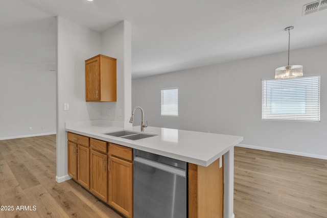 9261 W Sheridan St, Phoenix, AZ 85037 - kitchen with dishwasher, light wood-type flooring, and brown cabinetry