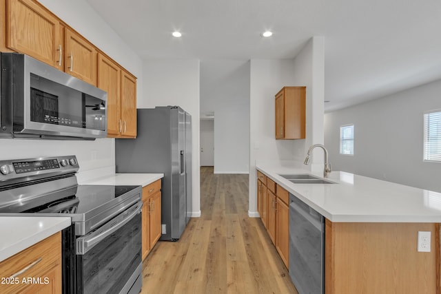 9261 W Sheridan St, Phoenix, AZ 85037 - kitchen featuring appliances with stainless steel finishes, light wood-style flooring, light countertops, a peninsula, and recessed lighting