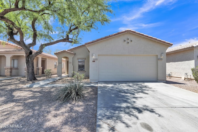 9261 W Sheridan St, Phoenix, AZ 85037 - mediterranean / spanish-style house featuring stucco siding, concrete driveway, a garage, and a tiled roof