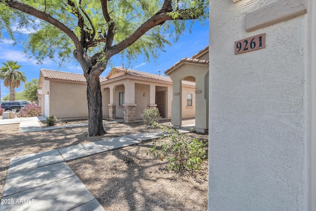 9261 W Sheridan St, Phoenix, AZ 85037 - view of front facade featuring stucco siding and a tile roof