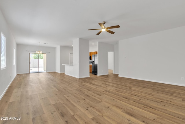 9261 W Sheridan St, Phoenix, AZ 85037 - unfurnished living room featuring light wood finished floors and ceiling fan