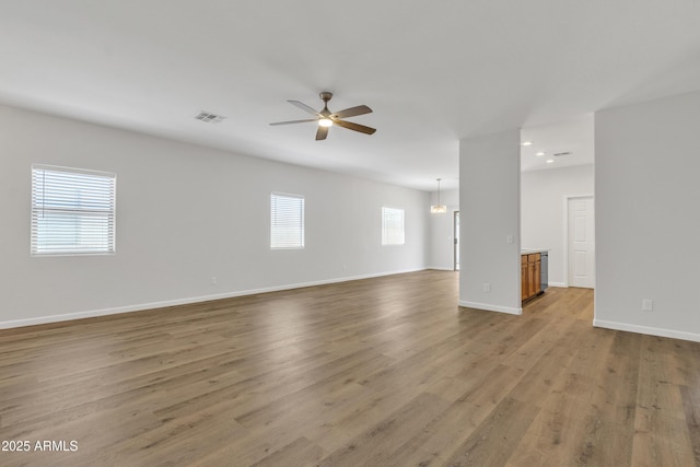 9261 W Sheridan St, Phoenix, AZ 85037 - unfurnished living room with ceiling fan, wood finished floors, and recessed lighting