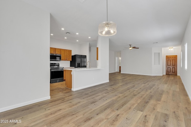 9261 W Sheridan St, Phoenix, AZ 85037 - unfurnished living room featuring a chandelier, light wood-type flooring, recessed lighting, and a ceiling fan