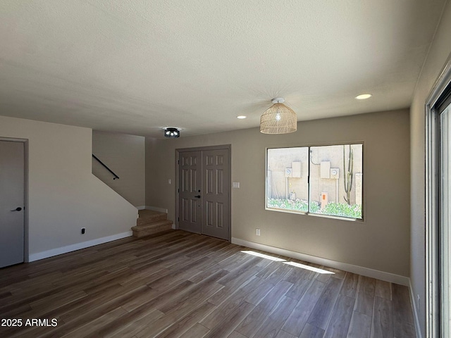 foyer entrance with plenty of natural light, stairs, wood finished floors, baseboards, and recessed lighting