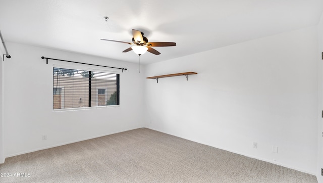 spare room with light carpet and ceiling fan