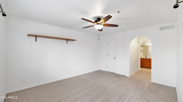 carpeted empty room featuring ceiling fan