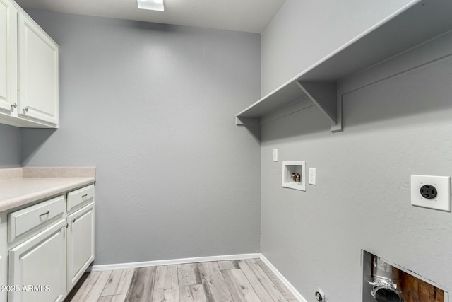 laundry room with light wood-style flooring, hookup for an electric dryer, washer hookup, baseboards, and cabinet space