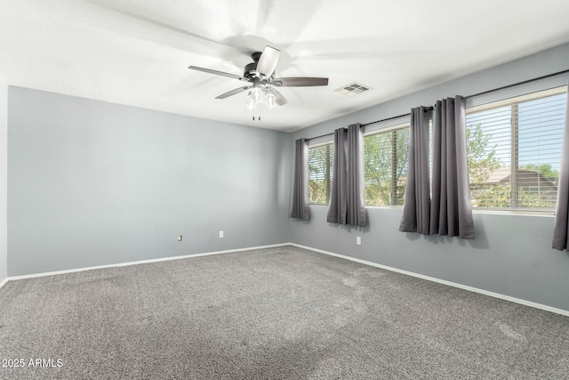 empty room featuring baseboards, visible vents, and carpet flooring