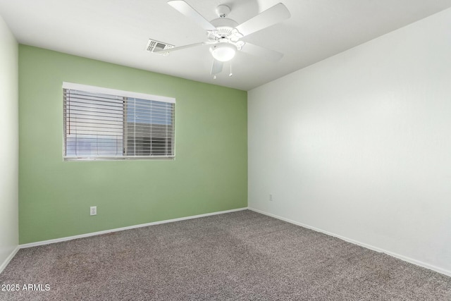 empty room with baseboards, carpet flooring, visible vents, and a ceiling fan