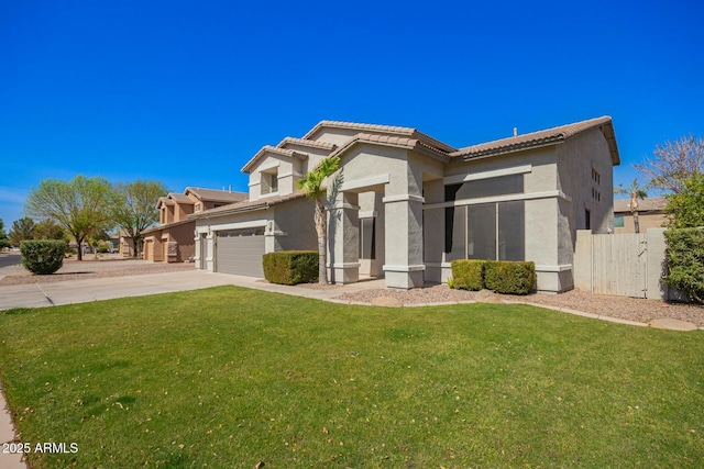 view of front facade featuring a garage, fence, concrete driveway, stucco siding, and a front yard