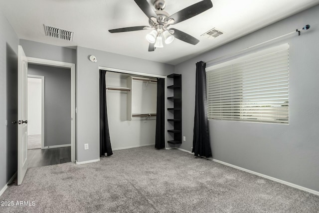 unfurnished bedroom with carpet floors, a closet, visible vents, and baseboards