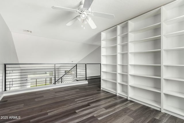 unfurnished room with lofted ceiling, dark wood-style floors, ceiling fan, and visible vents