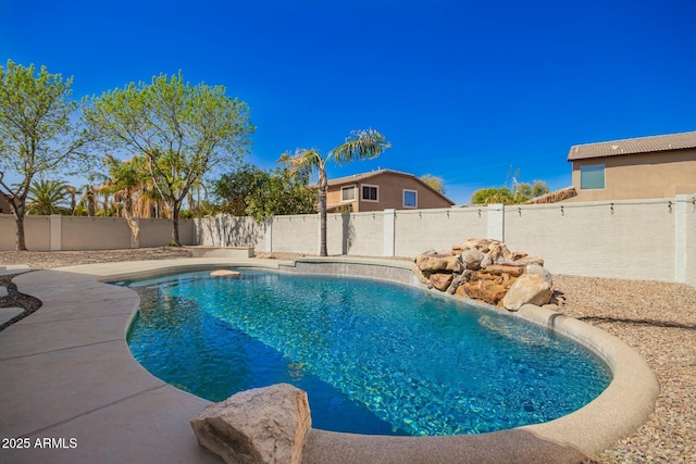 view of swimming pool featuring a fenced in pool and a fenced backyard