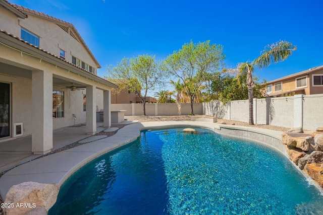 view of swimming pool featuring a fenced in pool, a patio area, a fenced backyard, and a ceiling fan