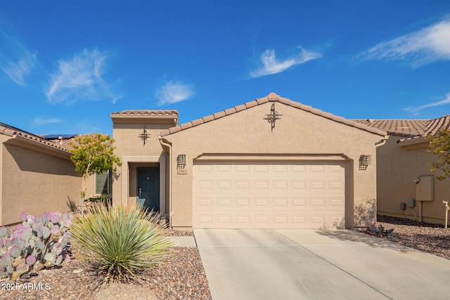 mediterranean / spanish-style house featuring stucco siding, driveway, a tile roof, and a garage