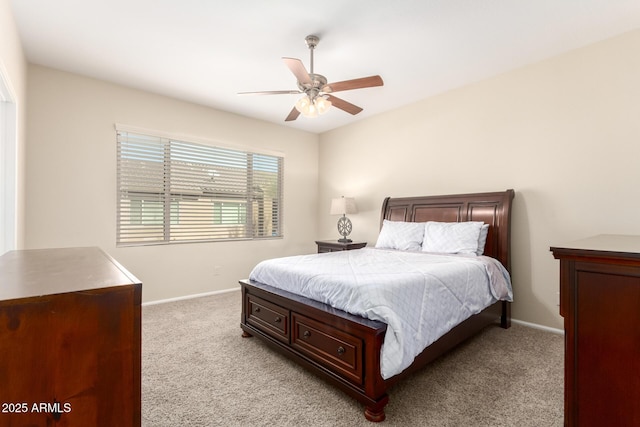 bedroom with light colored carpet, a ceiling fan, and baseboards