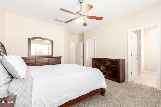 bedroom with light carpet, visible vents, and ceiling fan