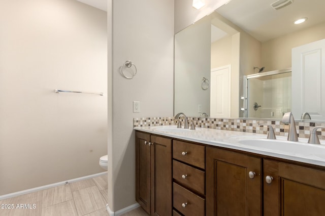 full bath featuring a shower stall, backsplash, and a sink