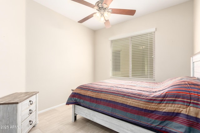 bedroom featuring a ceiling fan and baseboards